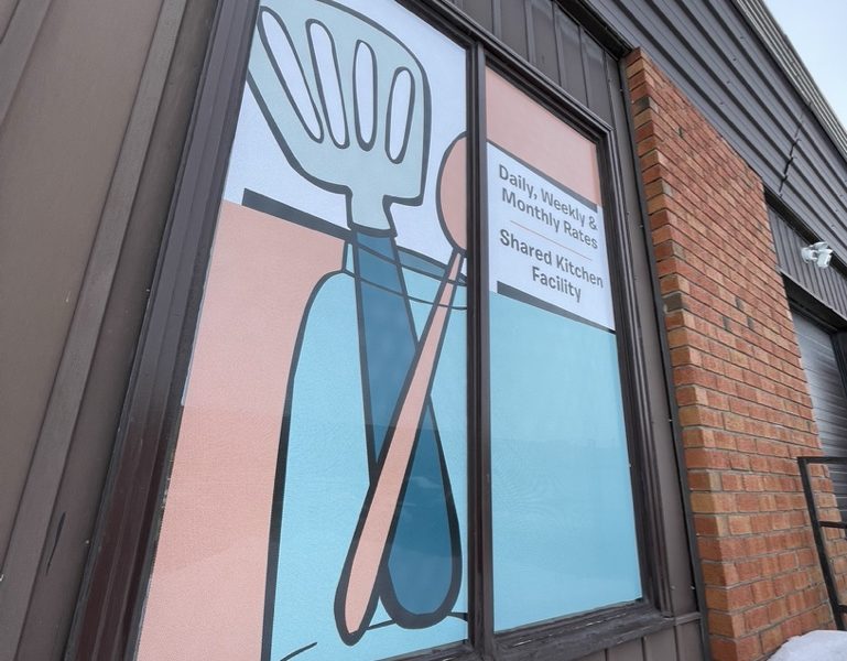 PERFORATED WINDOW GRAPHICS ON A COMMERCIAL BUILDING