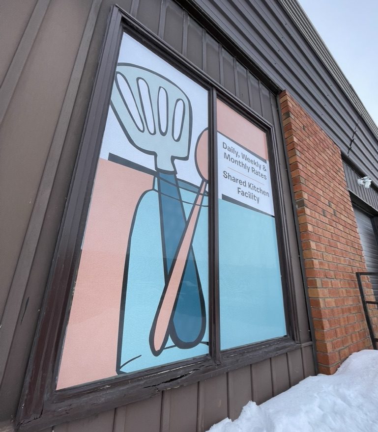 PERFORATED WINDOW GRAPHICS ON A COMMERCIAL BUILDING
